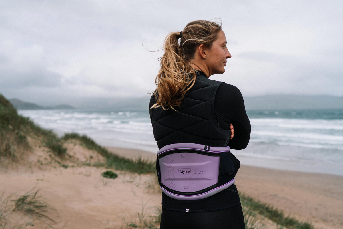 Kitester met de Mystic Ruby Impact Vest en trapeze aan het strand